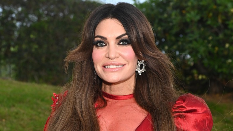 Kimberly Guilfoyle smiling in a red dress