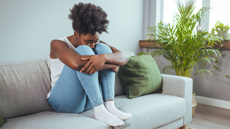 Woman sitting isolated on couch