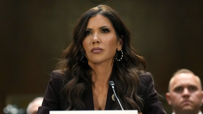 Kristi Noem pictured in 2026 testifying in the Dirksen Senate Office