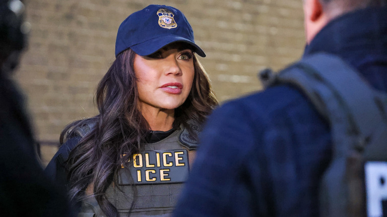 Kristi Noem dressed in a ball cap and bullet proof vest in New York City