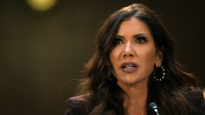 Kristi Noem speaking into a small microphone