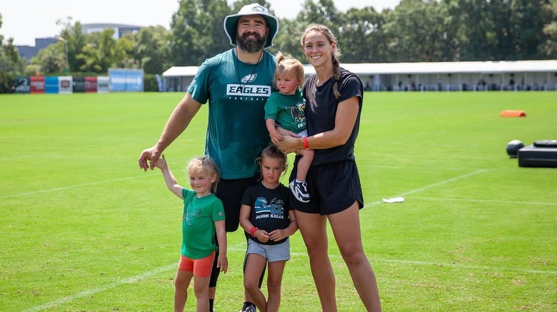The Kelce family on a field