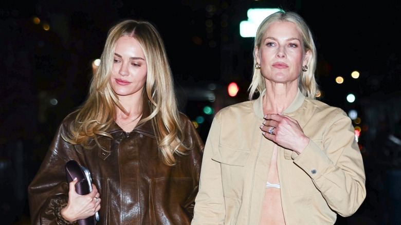 Ali Larter and Michelle Randolph posing on the red carpet together in front of an orange background