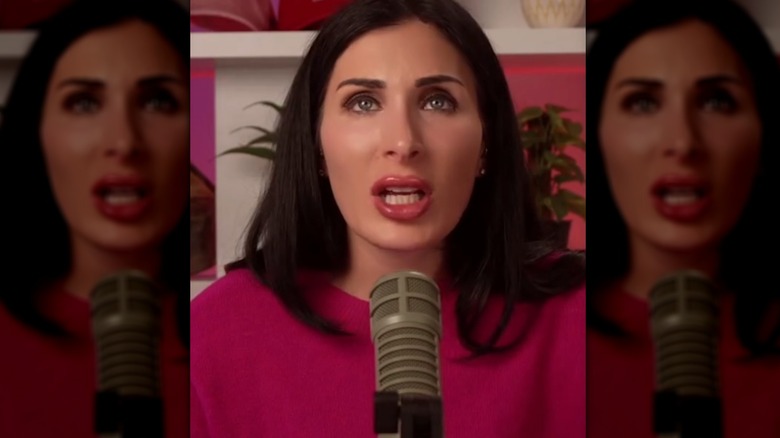 Laura Loomer speaking into a microphone