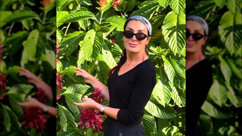 Laura Loomer in front of green leaves