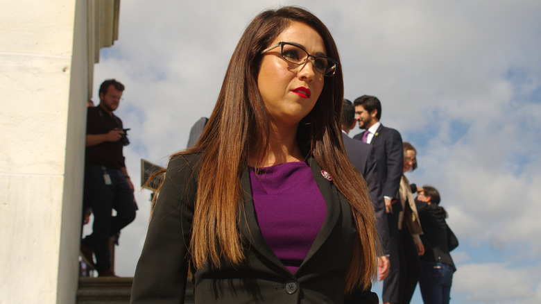 Lauren Boebert in an ill-fitted black blazer over a violet blouse.