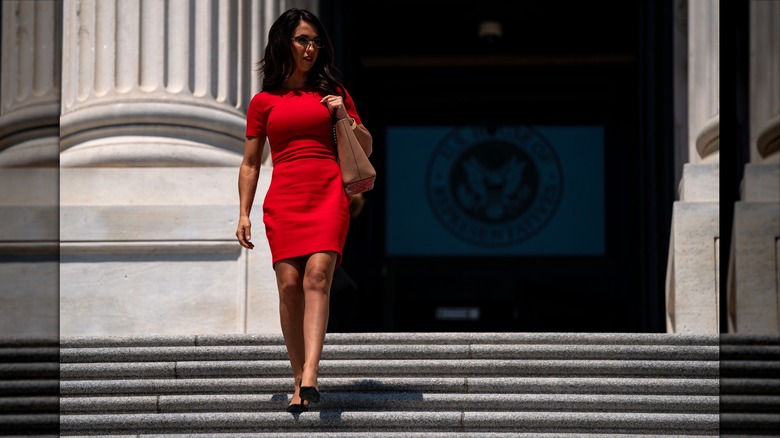 Lauren Boebert walking down stairs in a red dress