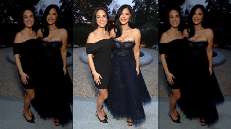 Lauren Sánchez Bezos wearing a sheer navy blue dress and standing next to another woman in a black dress