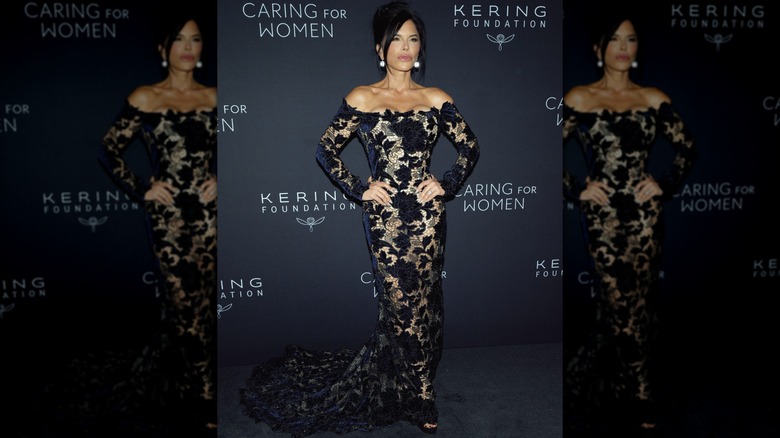 Lauren Sanchez in a sheer gown with navy blue flowers at an event