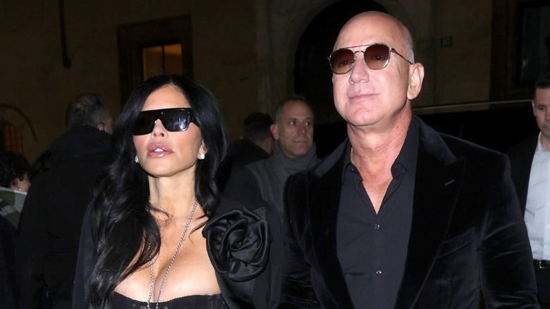 Lauren Sanchez in a black dress and Jeff Bezos in a dark outfit in Italy