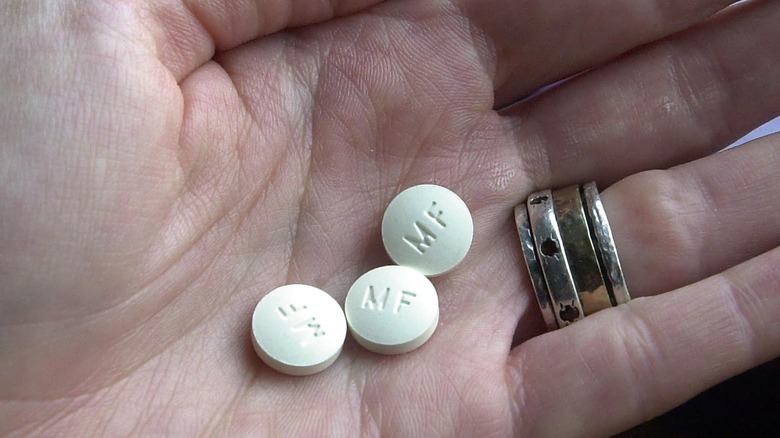 hand holding mifepristone pills