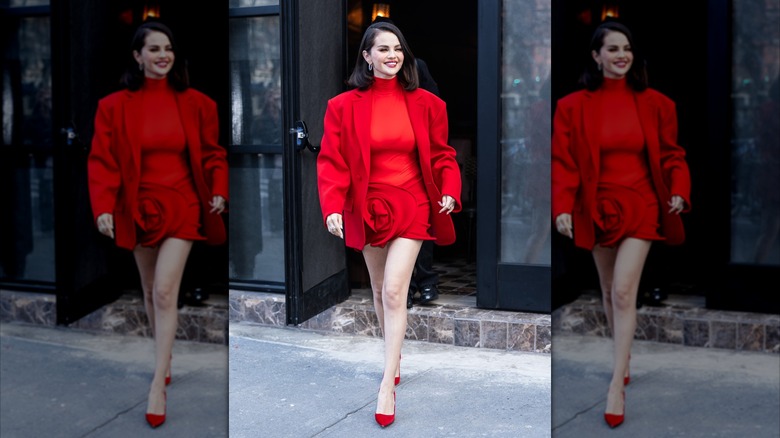 Selena Gomez in a red dress with matching coat and heels