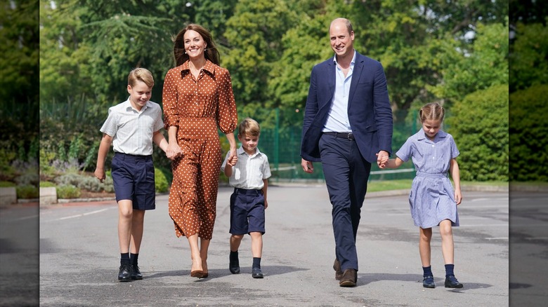 Catherine, Princess of Wales, walking with WIlliam, Prince of Wales, and their three children