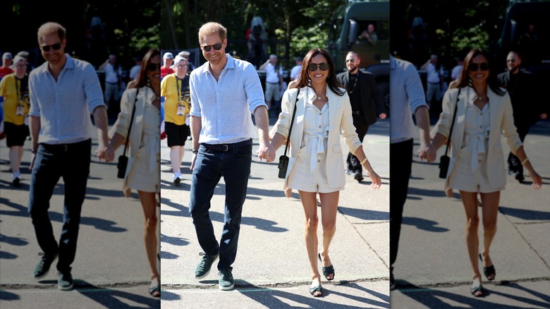 Meghan Markle wearing an all-white outfit and walking hand-in-hand with Prince Harry