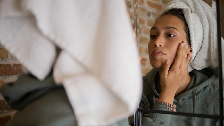 Woman moisturizes face