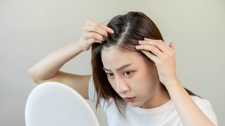 Woman looking for dandruff