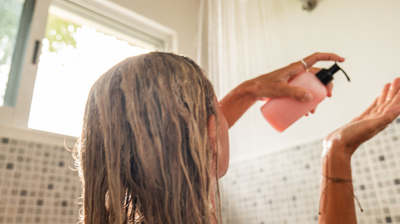 A woman washes her hair