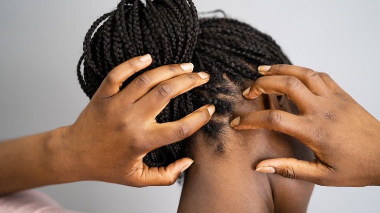 Woman scratches her head