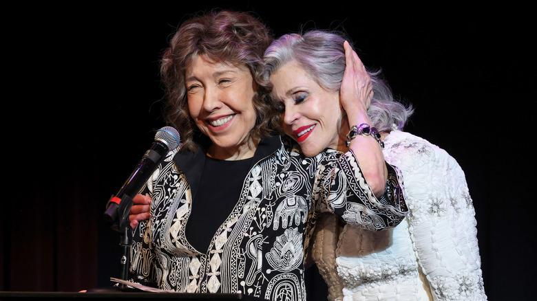 Lily Tomlin and Jane Fonda embracing each other on stage in 2024