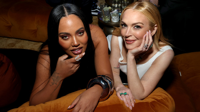 Ayesha Curry and Lindsay Lohan smile at the Oscars Party 2025