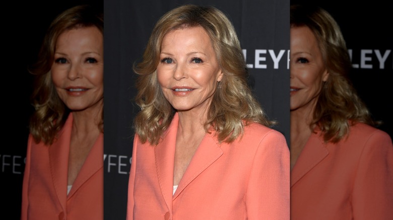 Close-up of Cheryl Ladd standing at an angle while smiling and wearing a peach-toned lip color