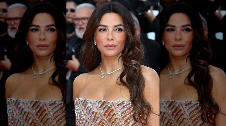 Close-up of Eva Longoria looking to the side while wearing a rosy, nude lip color and a sparkly, strapless gown