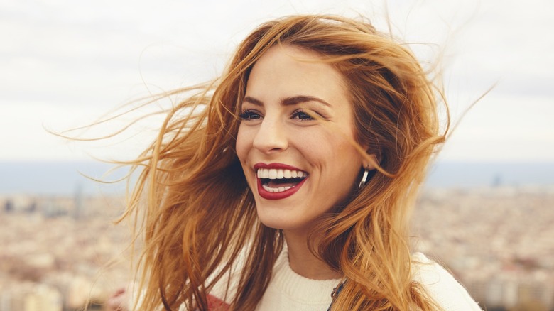 model smiling in red lipstick