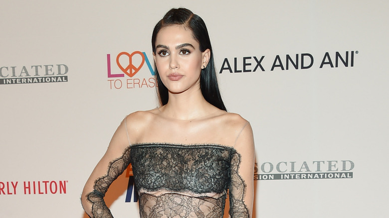 Amelia Hamlin poses wearing a black lace top