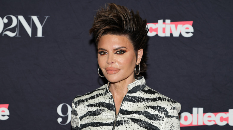 Lisa Rinna with short hair and wearing a black-and-white striped outfit