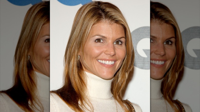 Lori Loughlin wearing a white turtleneck with light blond highlights