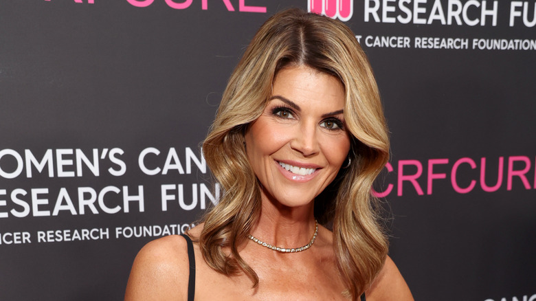 Lori Loughlin wearing a choker and black strapped dress