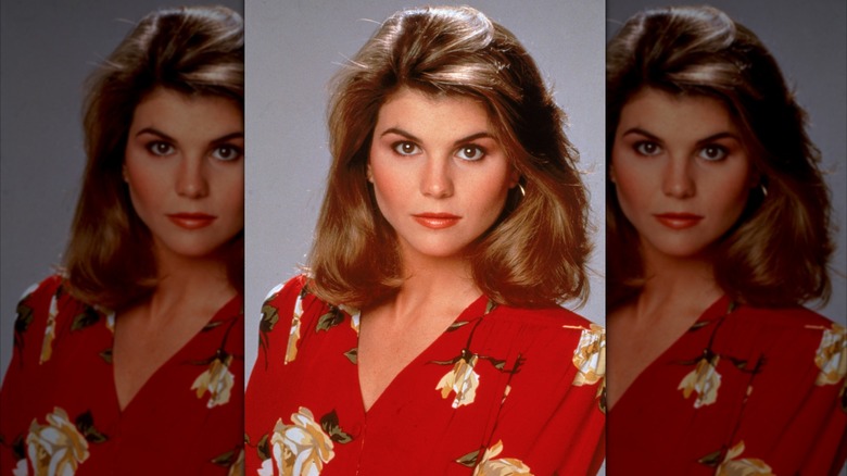 Lori Loughlin wearing a red blazer with floral motifs