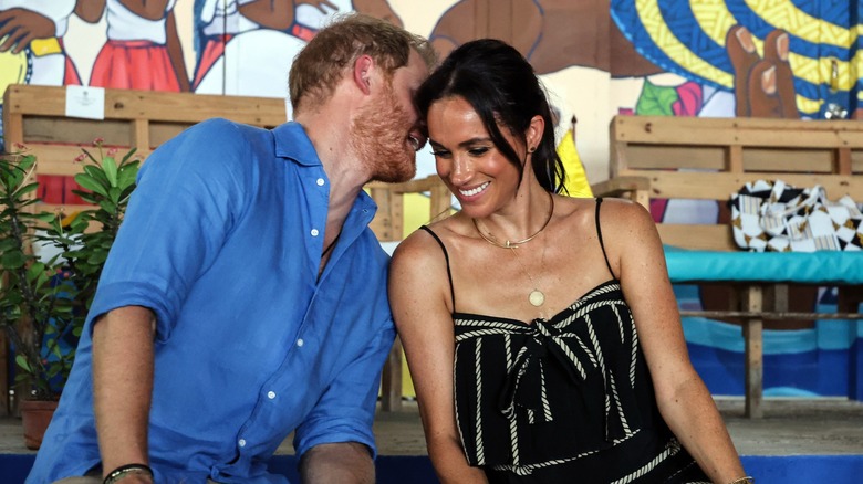 Prince Harry whispering something to Meghan Markle in Colombia