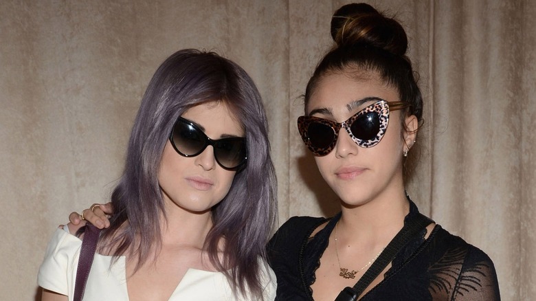 Lourdes Leon posing alongside Kelly Osbourne in 2012 wearing sunglasses and a black top