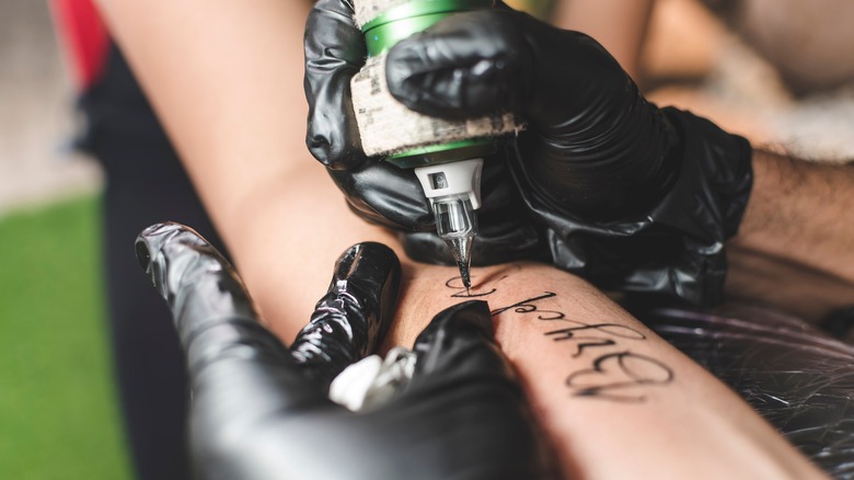 tattoo artist in gloves