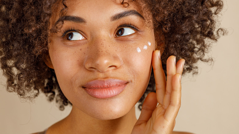 woman applying skincare