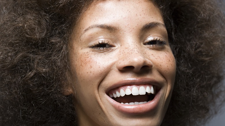Woman with freckles smiling 