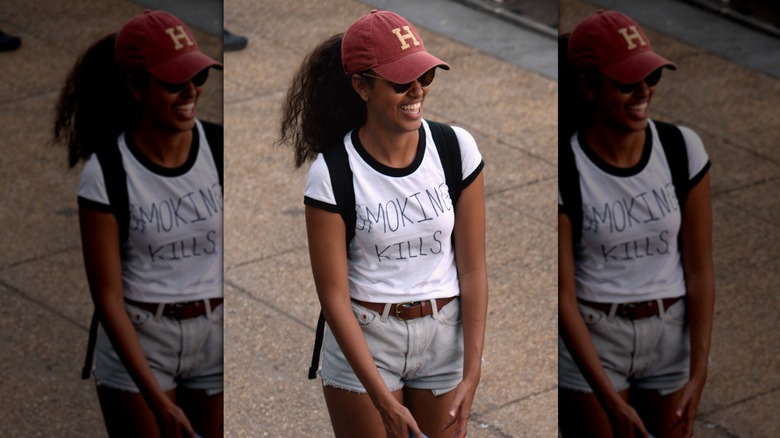 Malia Obama wearing her hair in a voluminous ponytail with a ball cap at the Budweiser Made in America Festival