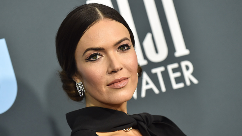 Mandy Moore on the red carpet wearing her dark hair pulled back