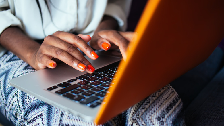 Woman with orange manicure 