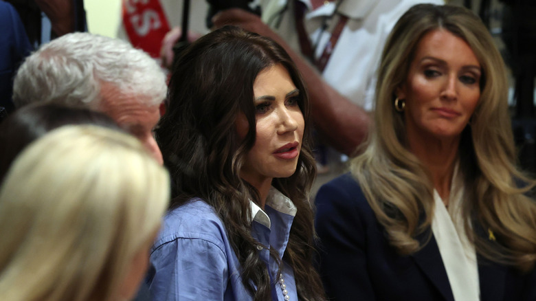 Kristi Noem sitting at a table with two other blonde women and a man