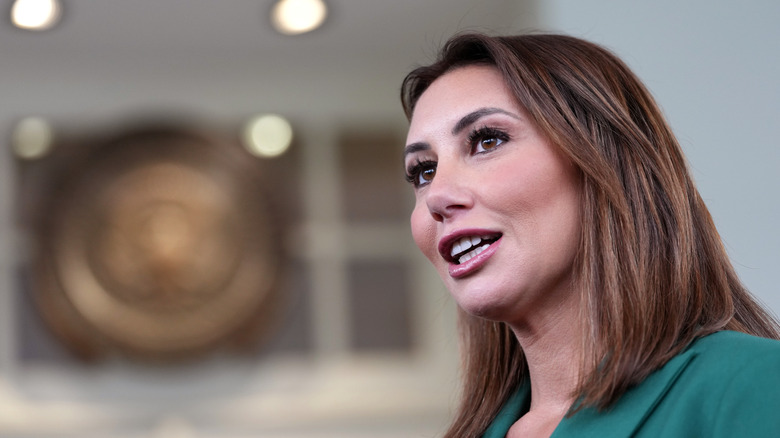 A side-profile shot of Alina Habba speaking