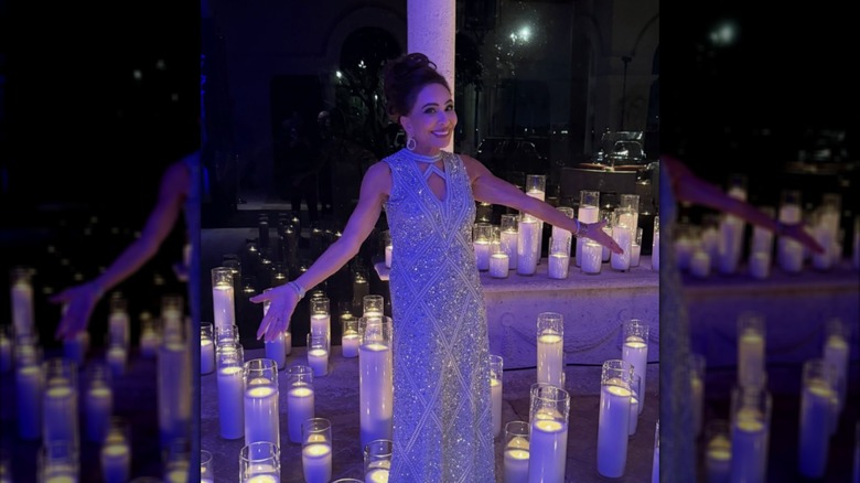 Jeanine Pirro in a sparkling blue dress and surrounded by candles