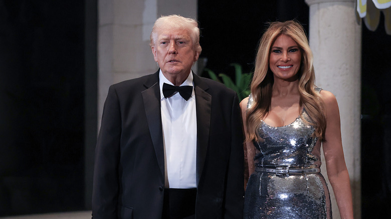 Barron Trump with Melania Trump standing behind him