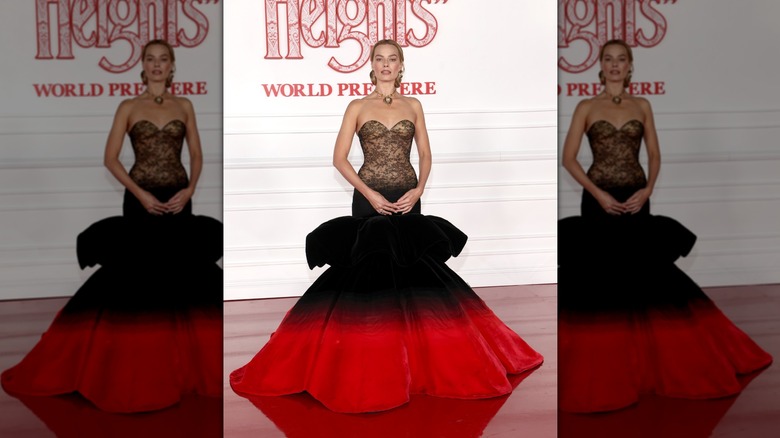 Margot Robbie on the red carpet in a strapless down with an exaggerated trumpet skirt