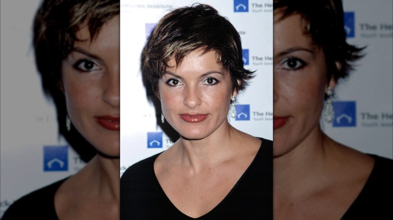 Mariska Hargitay wearing a black v neck top with pixie cut hair