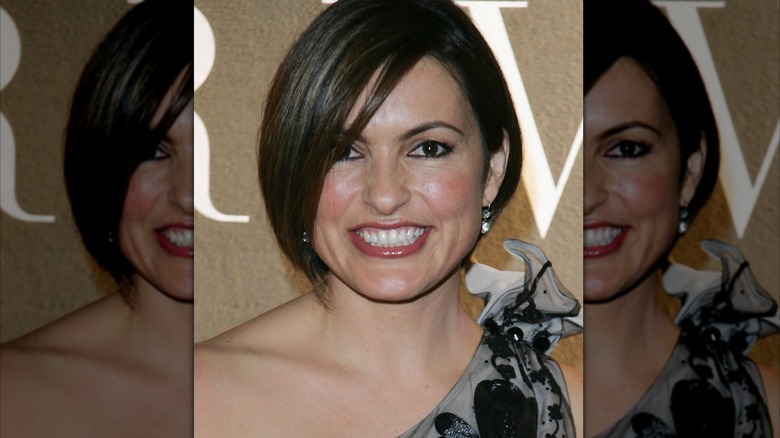 Mariska Hargitay wearing a silver earring and grey and black floral dress