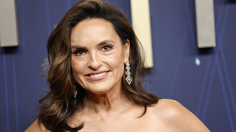 Mariska Hargitay wearing a diamond drop earring with lightly highlighted hair