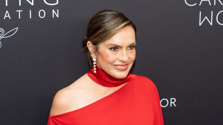 Mariska Hargitay wearing a red dress with long silver earrings