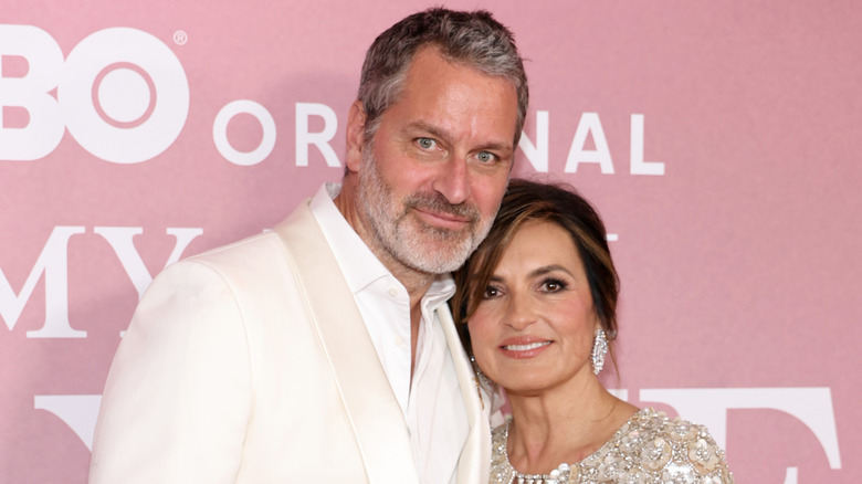 Peter Hermann and Mariska Hargitay smiles on the red carpet in 2025